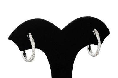 Lot 337 - A PAIR OF DIAMOND HOOP EARRINGS, mounted in...