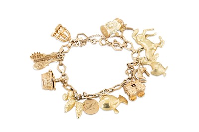 Lot 332 - A GOLD BRACELET, with various charms attached,...