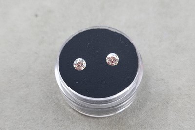 Lot 132 - TWO LOOSE ROUND BRILLIANT CUT DIAMONDS, the...