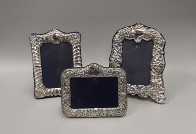 Lot 461 - THREE SILVER EMBOSSED PHOTO FRAMES, with...