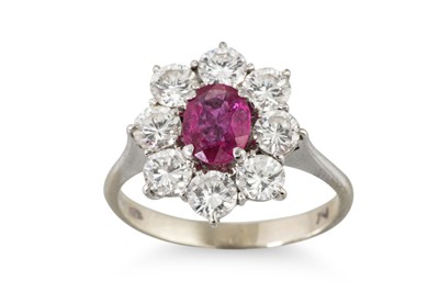 Lot 212 - A RUBY AND DIAMOND CLUSTER RING, the central...