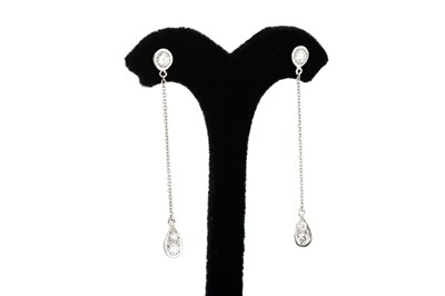 Lot 253 - A PAIR OF DIAMOND DROP EARRINGS, the round...