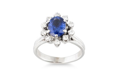 Lot 262 - A SAPPHIRE AND DIAMOND CLUSTER RING, the oval...