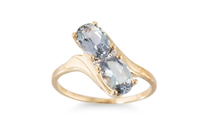 Lot 106 - A TOPAZ CLUSTER RING, of cross over style, the...