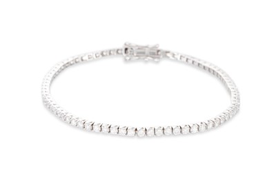Lot 85 - A DIAMOND LINE BRACELET, the brilliant cut...