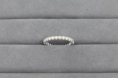 A DIAMOND SET FULL ETERNITY RING, the round...