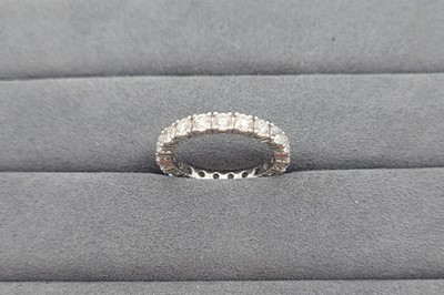 A DIAMOND SET FULL ETERNITY RING, the round...
