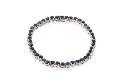 Lot 253 - A SAPPHIRE SET LINE BRACELET, the round cut...