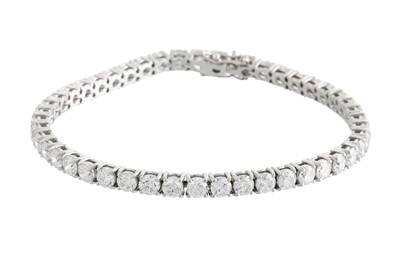 Lot 341 - A DIAMOND LINE BRACELET, the brilliant cut...