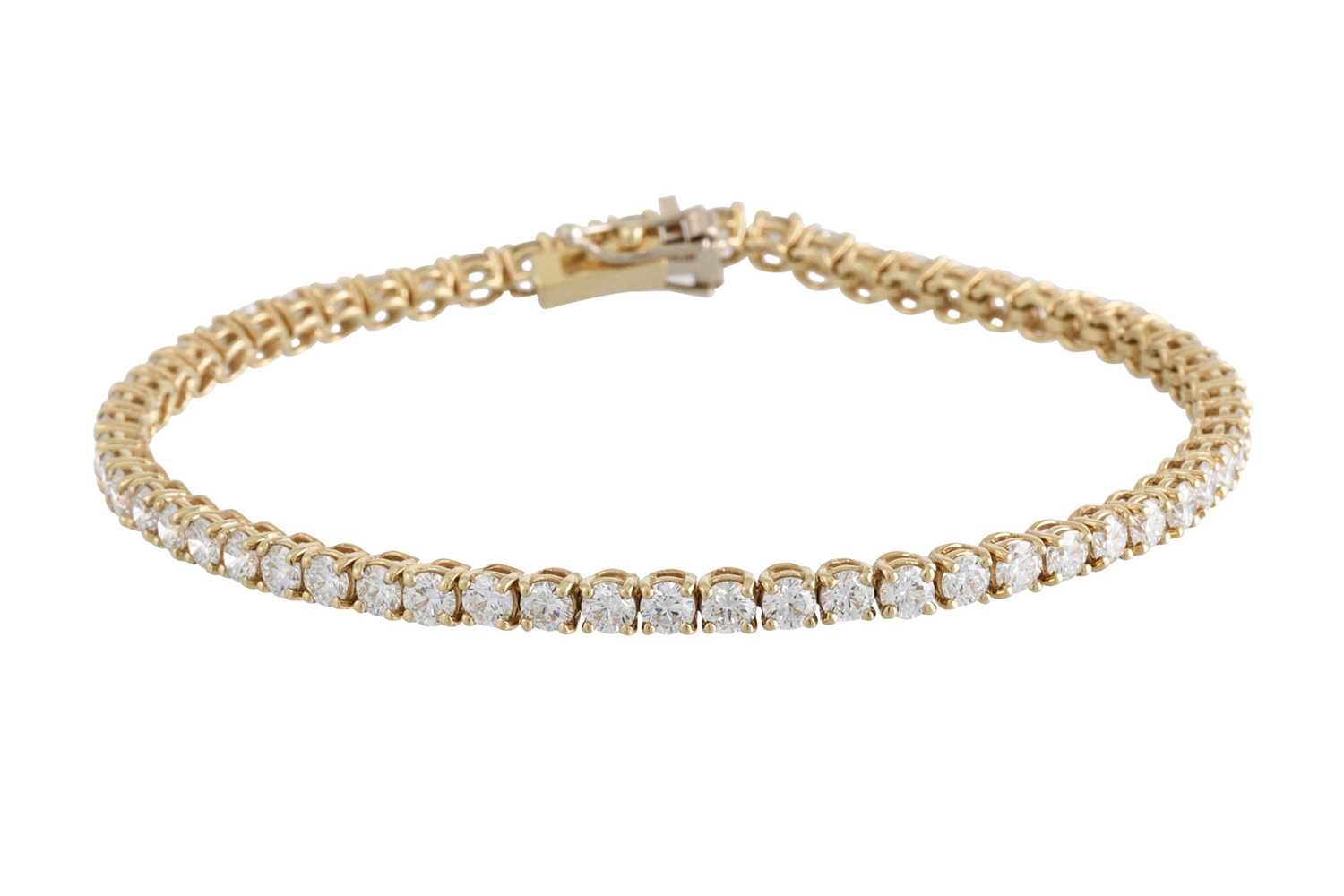 Lot 228 - A DIAMOND LINE BRACELET, the brilliant cut...