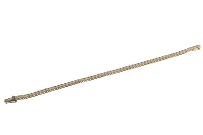 Lot 228 - A DIAMOND LINE BRACELET, the brilliant cut...