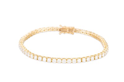 Lot 315 - A DIAMOND LINE BRACELET, the brilliant cut...