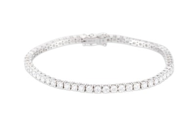 Lot 316 - A DIAMOND LINE BRACELET, the brilliant cut...