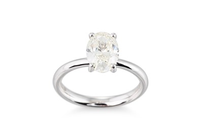 Lot 322 - A DIAMOND SET SOLITAIRE RING, the oval cut...