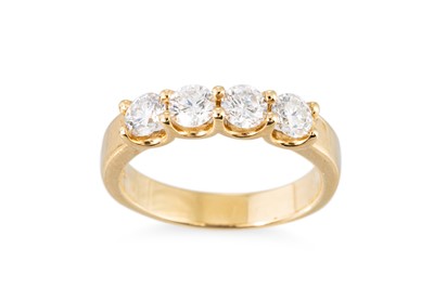 Lot 356 - A DIAMOND FOUR STONE RING, the round brilliant...