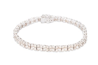 Lot 375 - A DIAMOND CLUSTER BRACELET, the brilliant cut...