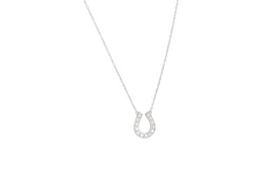 Lot 21 - A DIAMOND SET HORSESHOE PENDANT, the round cut...