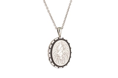 Lot 24 - A VINTAGE SILVER/COMPOSITE LOCKET, to a white...