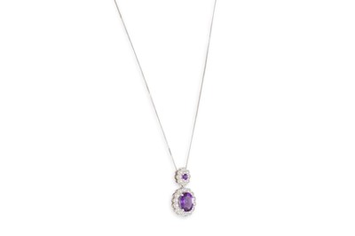 Lot 41 - AN AMETHYST AND DIAMOND SET CLUSTER PENDANT,...