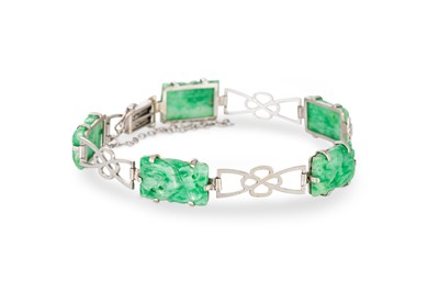 Lot 96 - A JADE BRACELET, the carved jade panels set to...