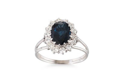 Lot 230 - A DIAMOND AND SAPPHIRE CLUSTER RING, the oval...