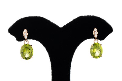 Lot 203 - A PAIR OF PERIDOT AND DIAMOND DROP EARRINGS,...