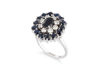 Lot 212 - A SAPPHIRE AND DIAMOND CLUSTER RING, the oval...