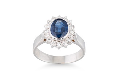 Lot 214 - A SAPPHIRE AND DIAMOND RING, the oval sapphire...