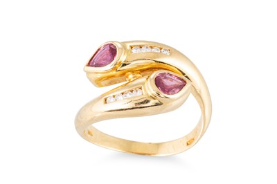 Lot 266 - A RUBY AND DIAMOND CROSS-OVER RING, set with...