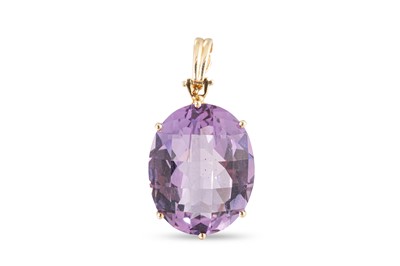 Lot 10 - AN AMETHYST SET PENDANT, the oval mixed cut...