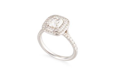 Lot 145 - A TIFFANY & CO DIAMOND 'HALO' SOLITAIRE RING,...
