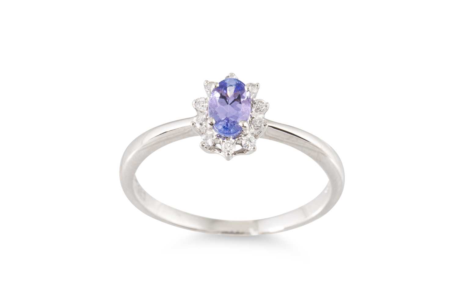 Lot 75 - A TANZANITE AND DIAMOND CLUSTER RING, mounted...
