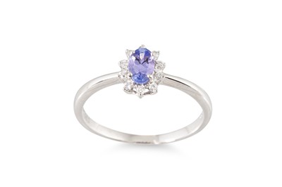 Lot 184 - A TANZANITE AND DIAMOND CLUSTER RING, mounted...