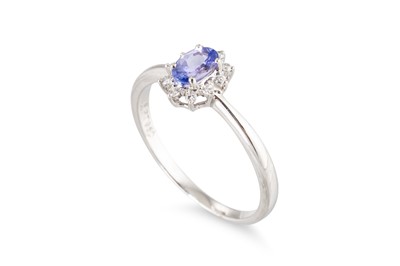 Lot 75 - A TANZANITE AND DIAMOND CLUSTER RING, mounted...