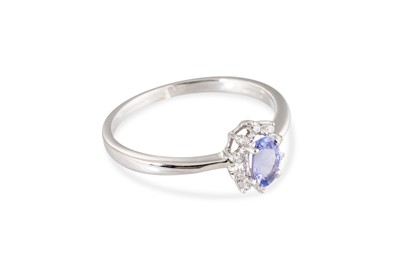 Lot 75 - A TANZANITE AND DIAMOND CLUSTER RING, mounted...