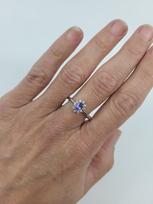 Lot 75 - A TANZANITE AND DIAMOND CLUSTER RING, mounted...