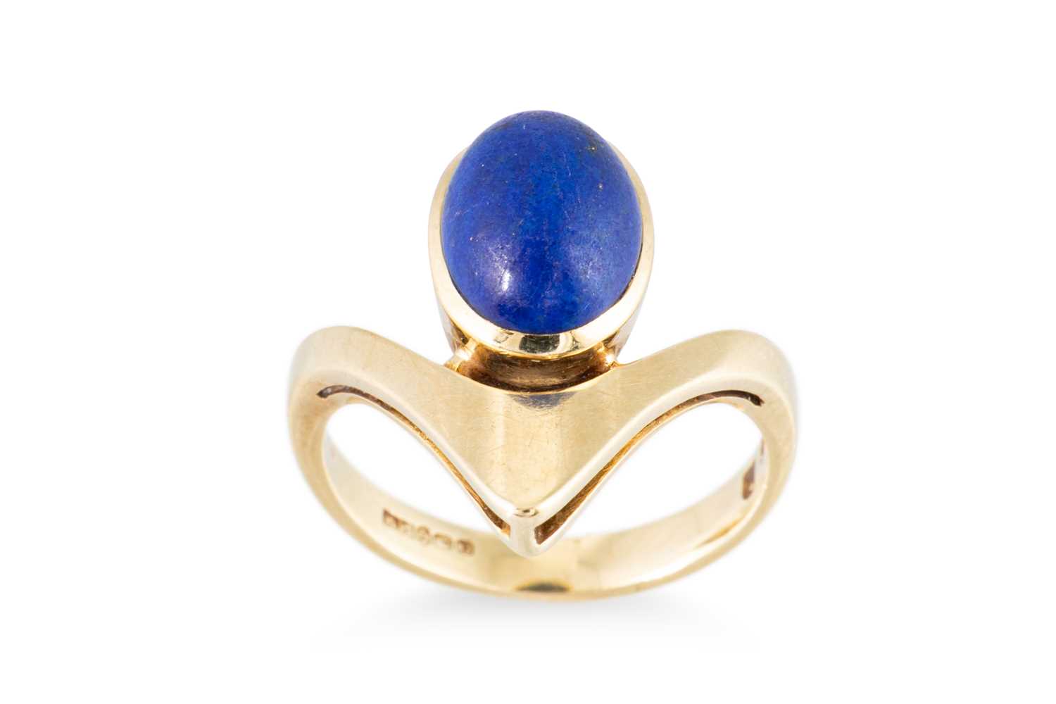 Lot 77 - A 1970S DESIGNER RING, set with lapis lazuli,...