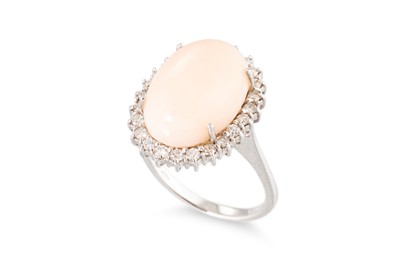 Lot 102 - A CORAL AND DIAMOND SET CLUSTER RING,  the...