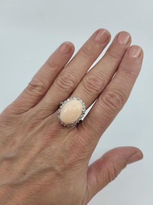 Lot 193 - A CORAL AND DIAMOND SET CLUSTER RING, the...