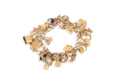 Lot 8 - A 9CT GOLD CHARM BRACELET, most charms...
