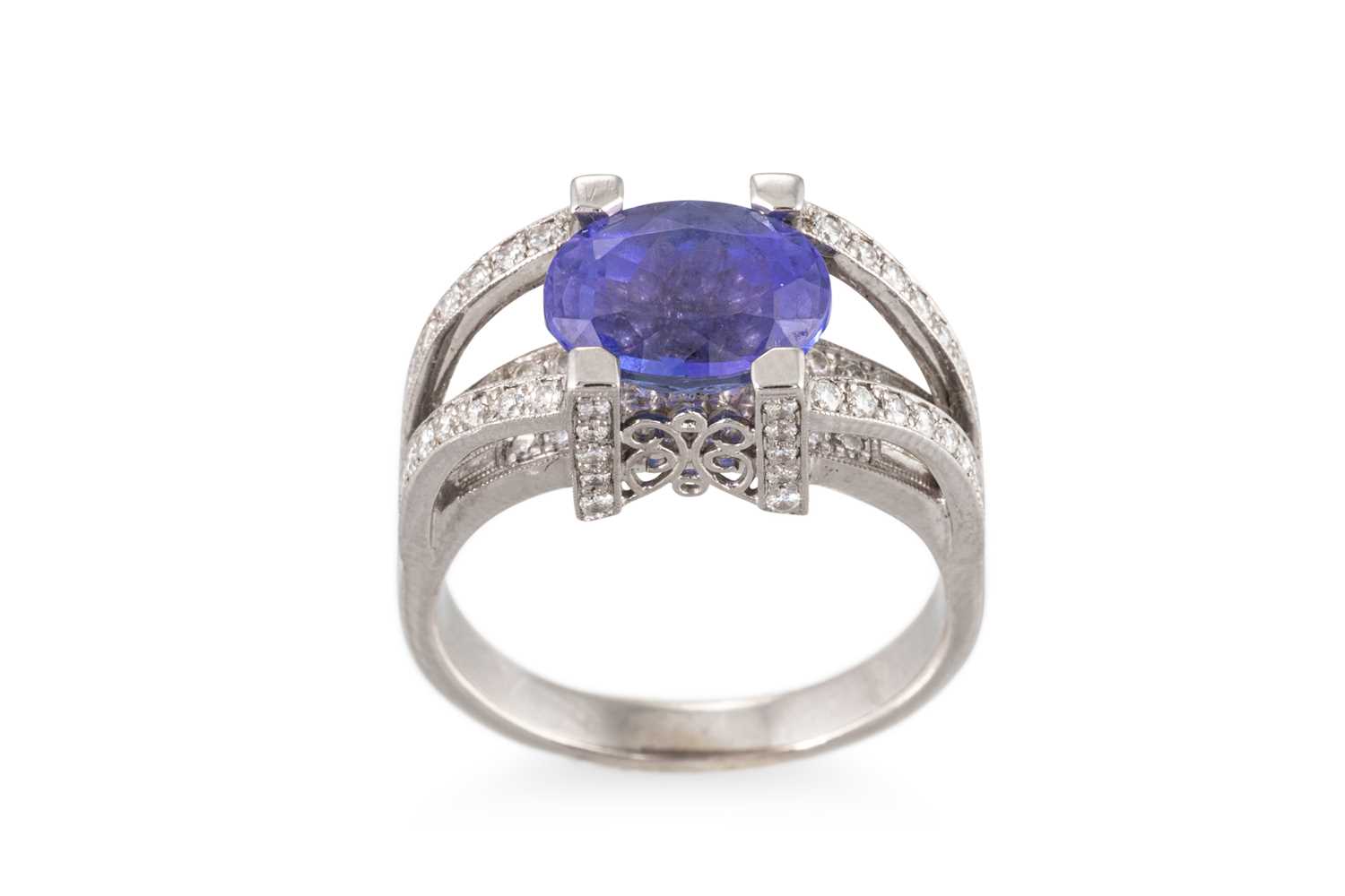 Lot 179 - A TANZANITE AND DIAMOND SET RING, the oval...