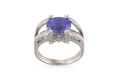 Lot 179 - A TANZANITE AND DIAMOND SET RING, the oval...