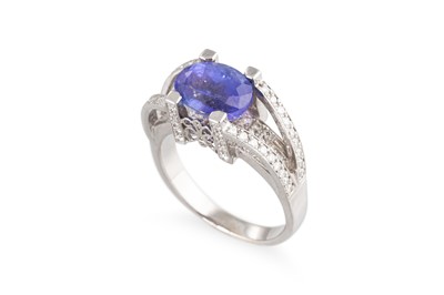 Lot 179 - A TANZANITE AND DIAMOND SET RING, the oval...
