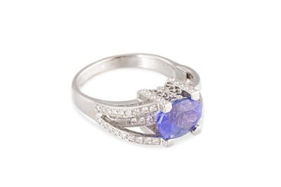 Lot 179 - A TANZANITE AND DIAMOND SET RING, the oval...