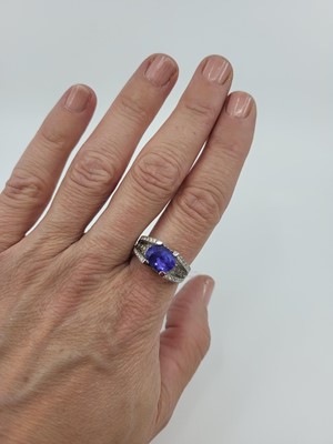 Lot 179 - A TANZANITE AND DIAMOND SET RING, the oval...