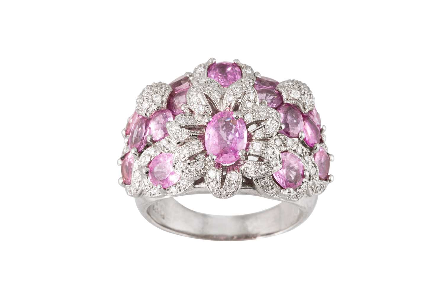 Lot 180 - A PINK SAPPHIRE AND DIAMOND CLUSTER RING, of...