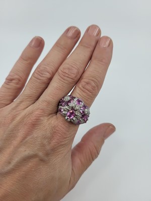 Lot 180 - A PINK SAPPHIRE AND DIAMOND CLUSTER RING, of...