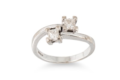 Lot 245 - A DIAMOND TWO-STONE RING, the toi et moi dress...