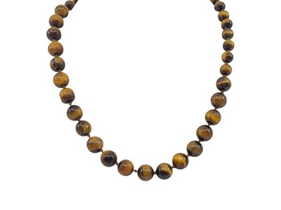 Lot 133 - A TIGER'S EYE BEADED NECKLACE, to a gold clasp