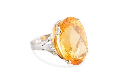 Lot 140 - A CITRINE COCKTAIL RING, the large oval stone...